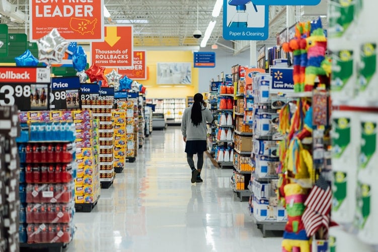 Person walking through supermarket, illustrating e-commerce growth
