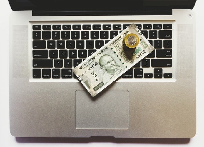 Laptop with currency on top